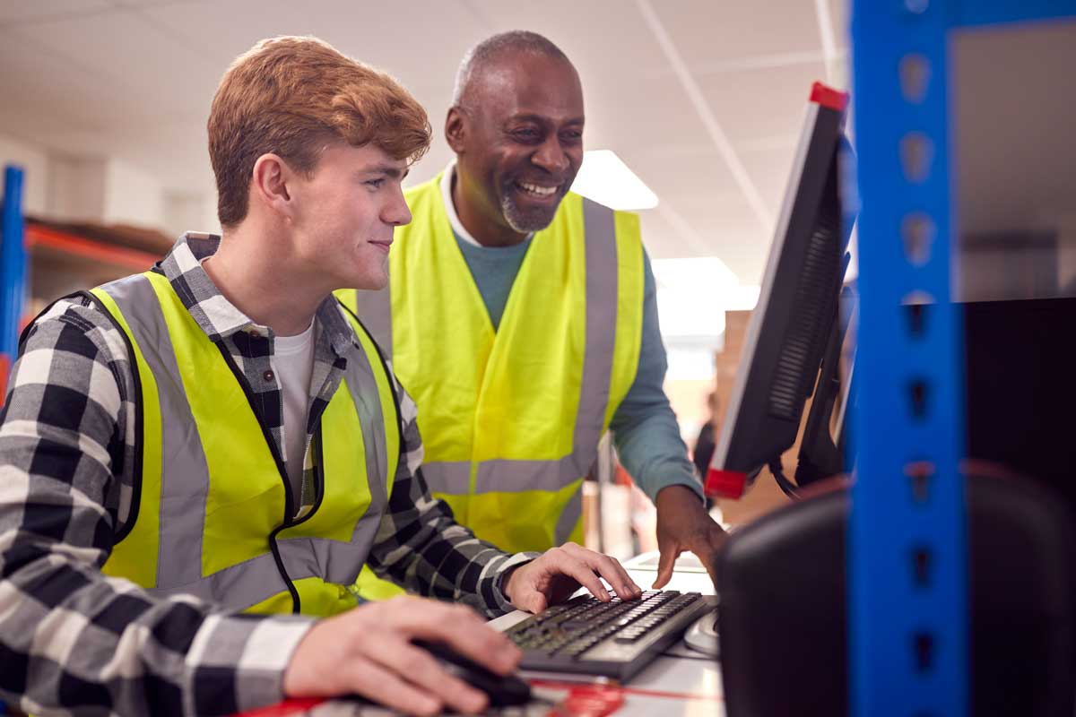apprentice learnings from teacher wearing yellow vest